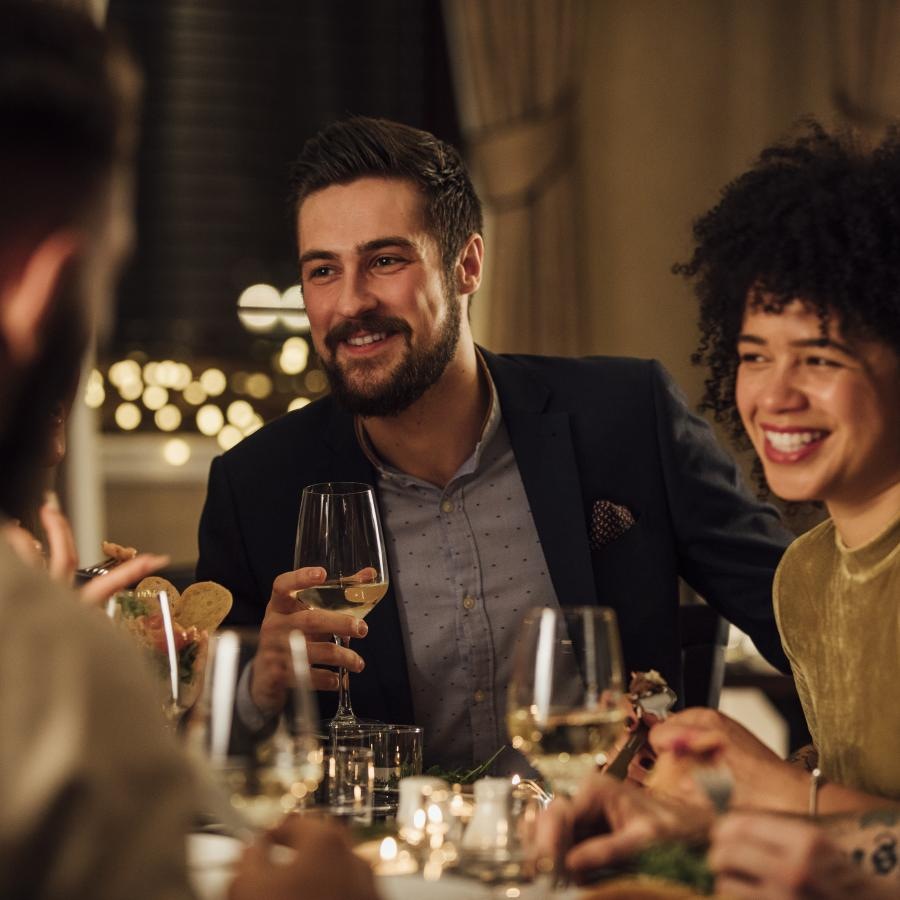 a group of people sitting at a table with wine glasses